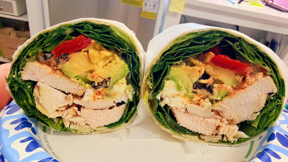 Colorful drinks and healthy lunch items on a table.